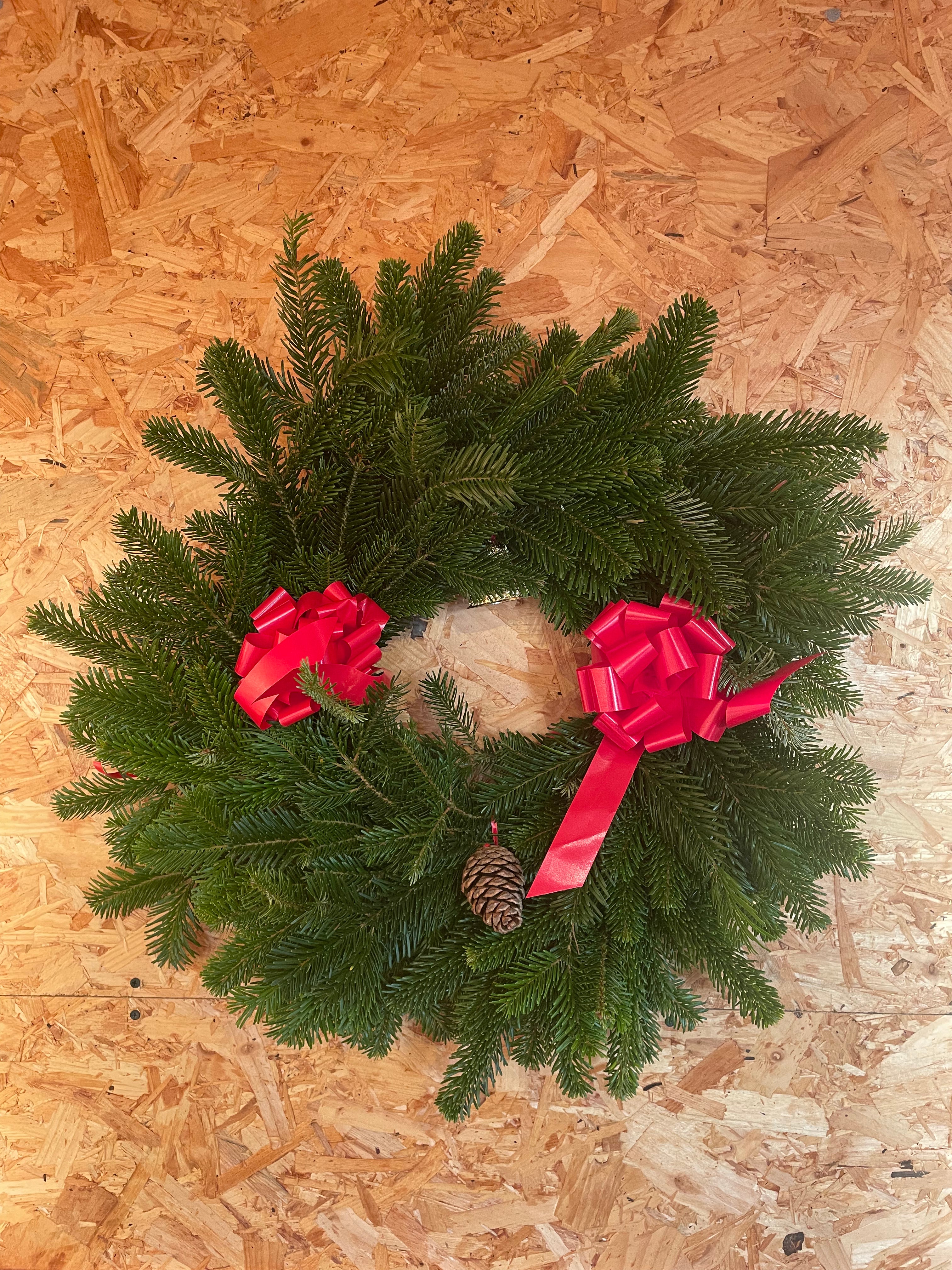 Handcrafted decorated Christmas Fir wreath with festive decorations, available for local delivery and click & collect with your Christmas tree order from The Real Christmas Tree People.